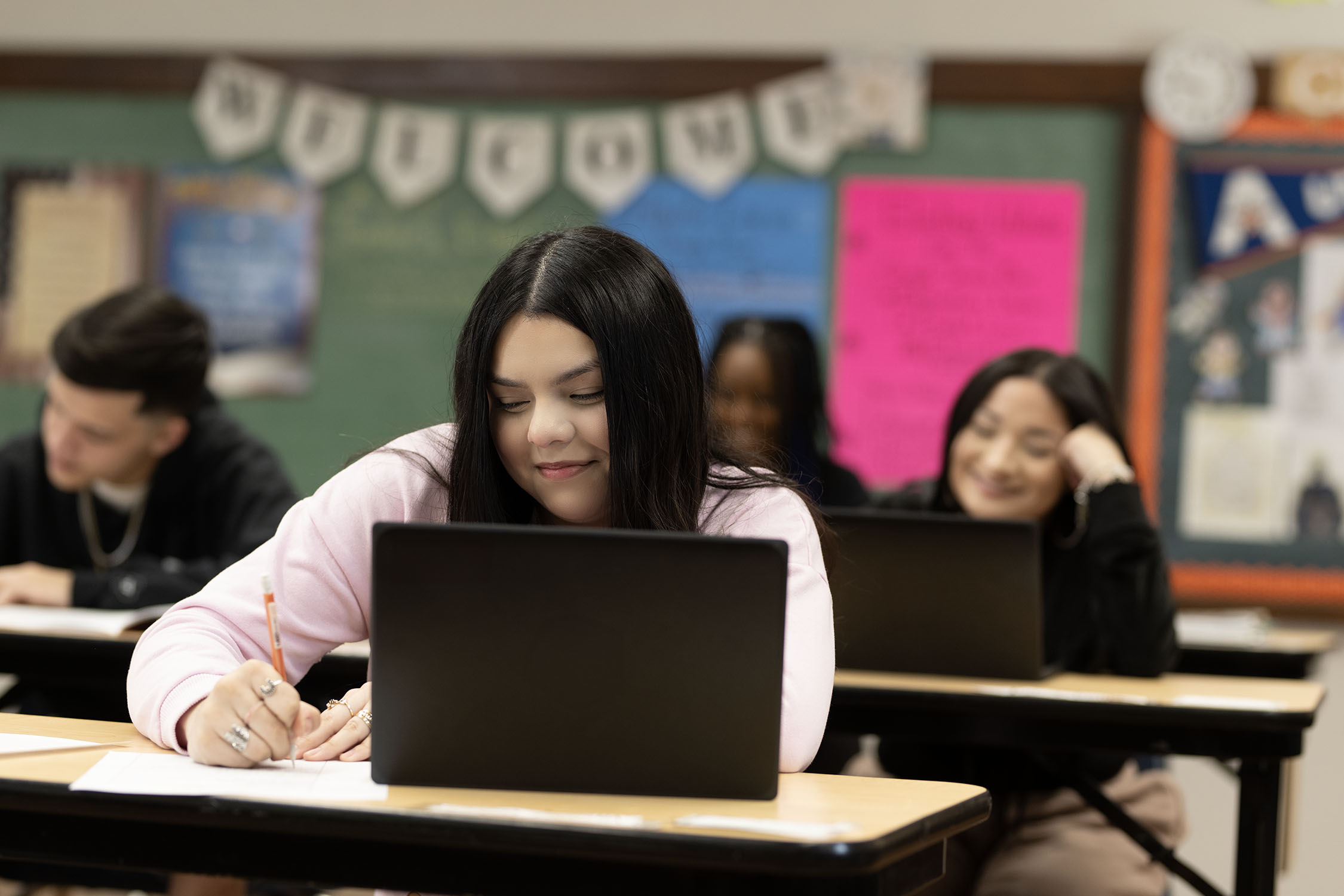 Students using laptops during a high school class.