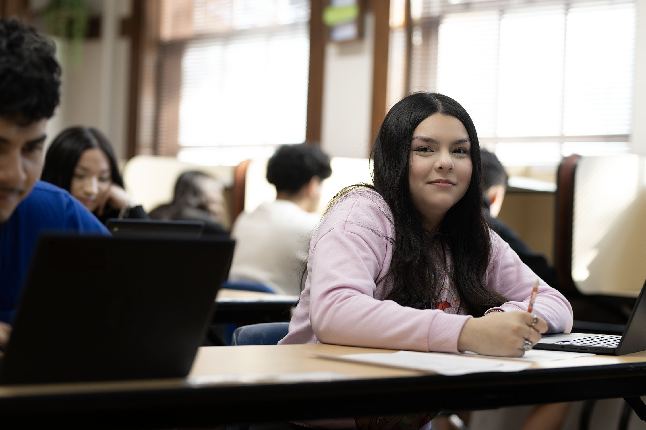 Female student smiling in a classroom setting