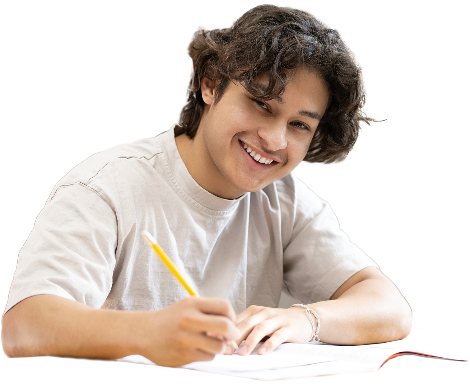 Young man smiling while writing in notebook