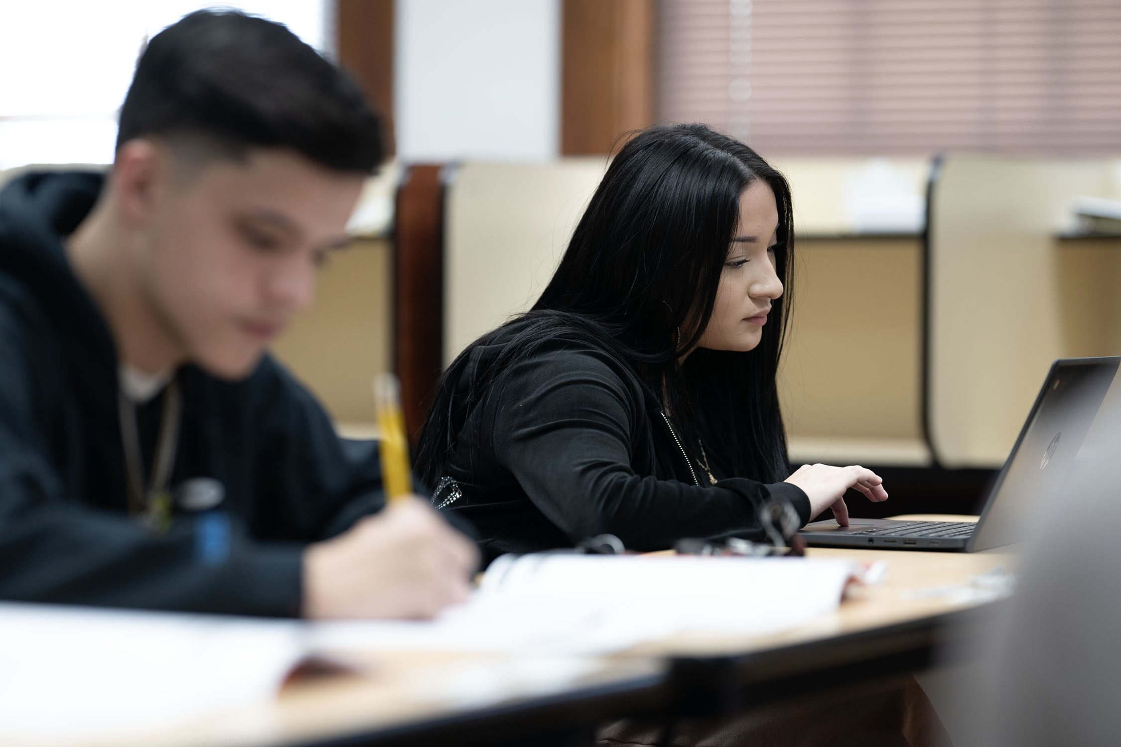 Students working on laptops in classroom setting