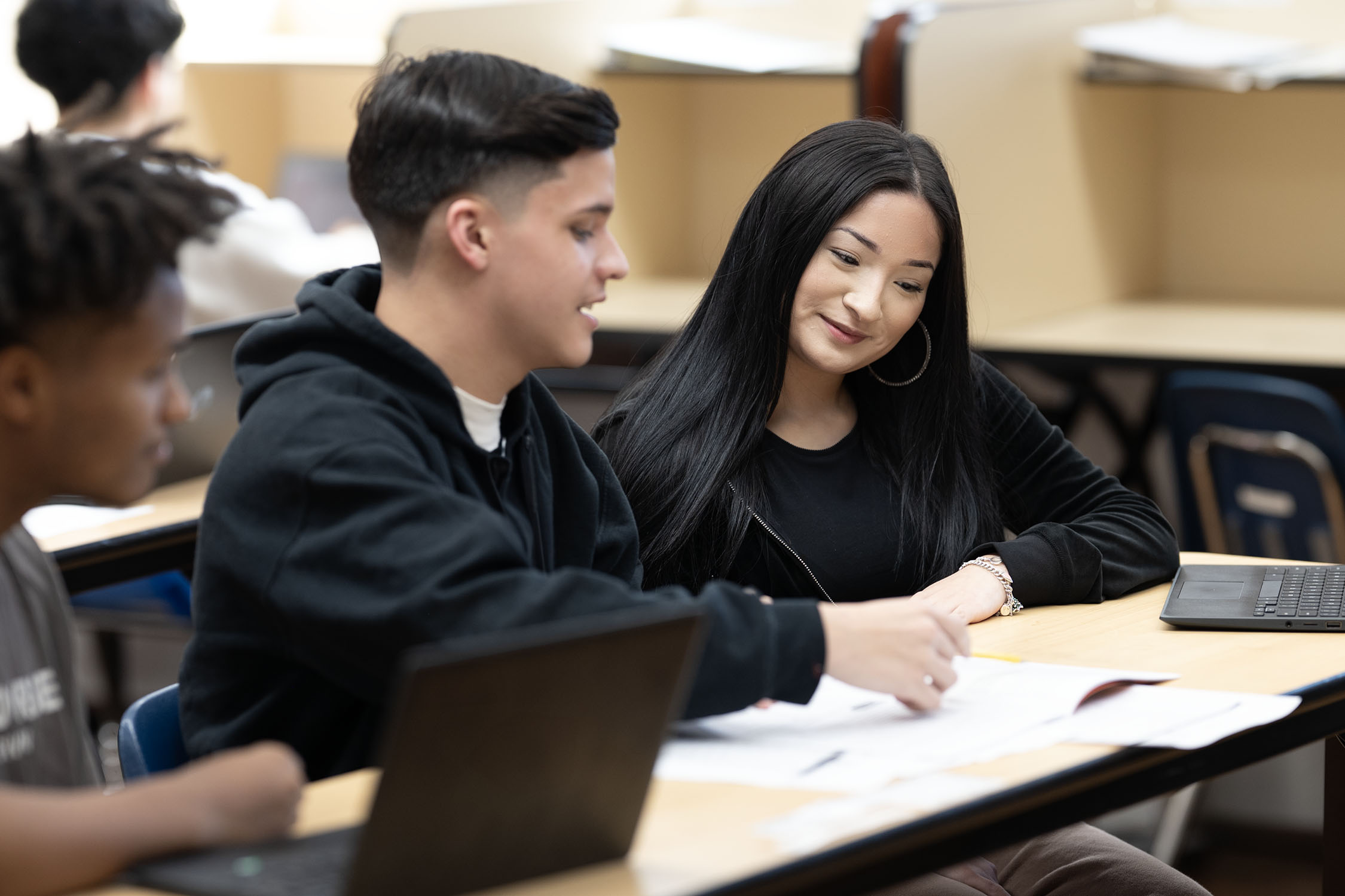 Students collaborating on project in classroom setting.