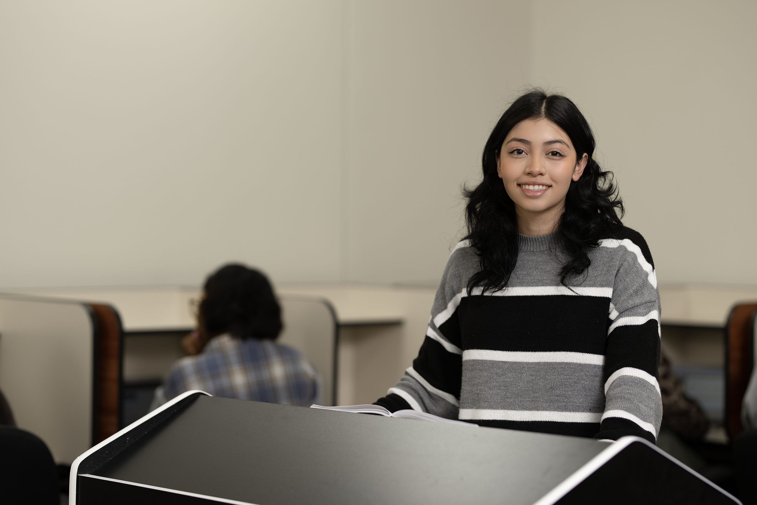Young woman smiling in a classroom setting