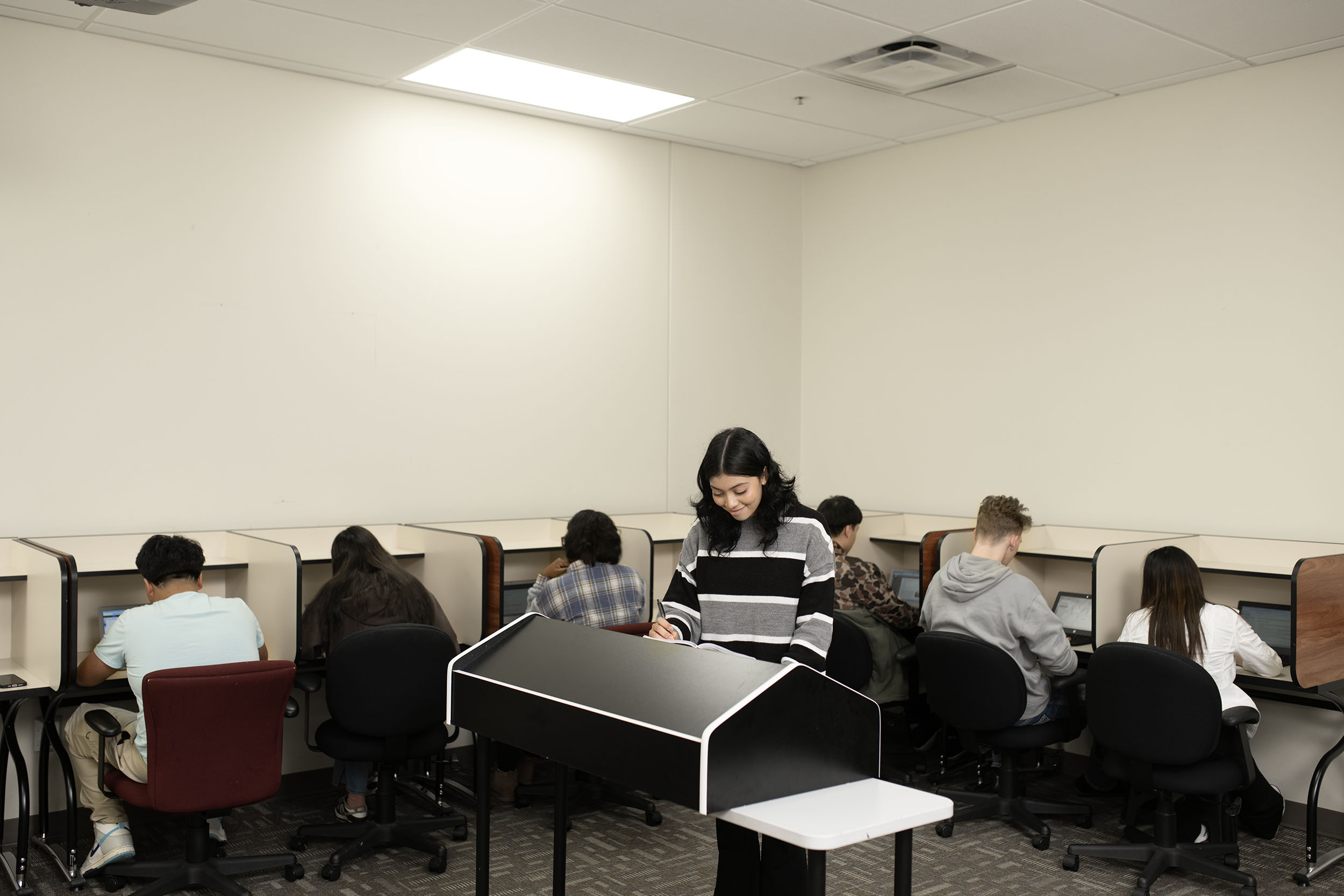 Students studying quietly in a modern classroom.