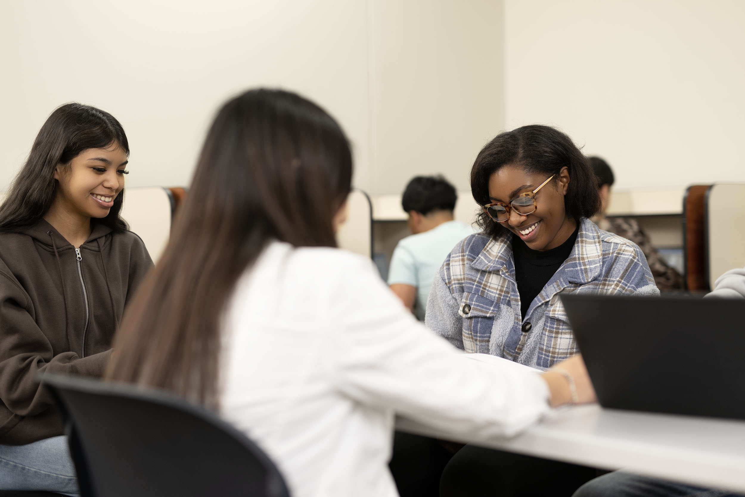 Students engaging with laptops in classroom setting