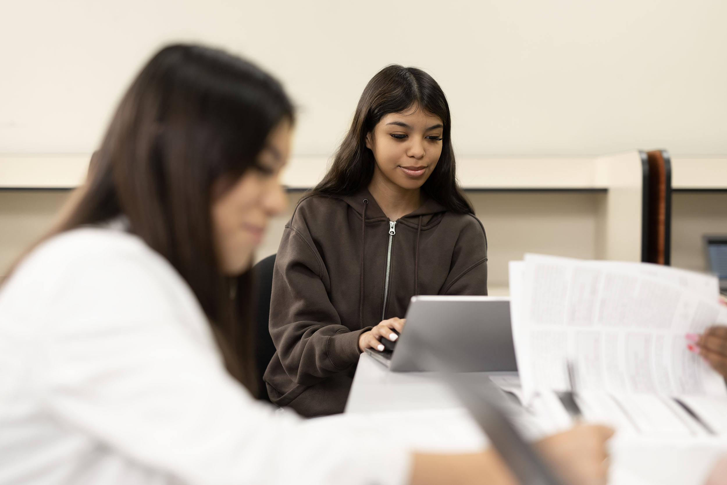 Students engaged in studying with digital tablet and paper