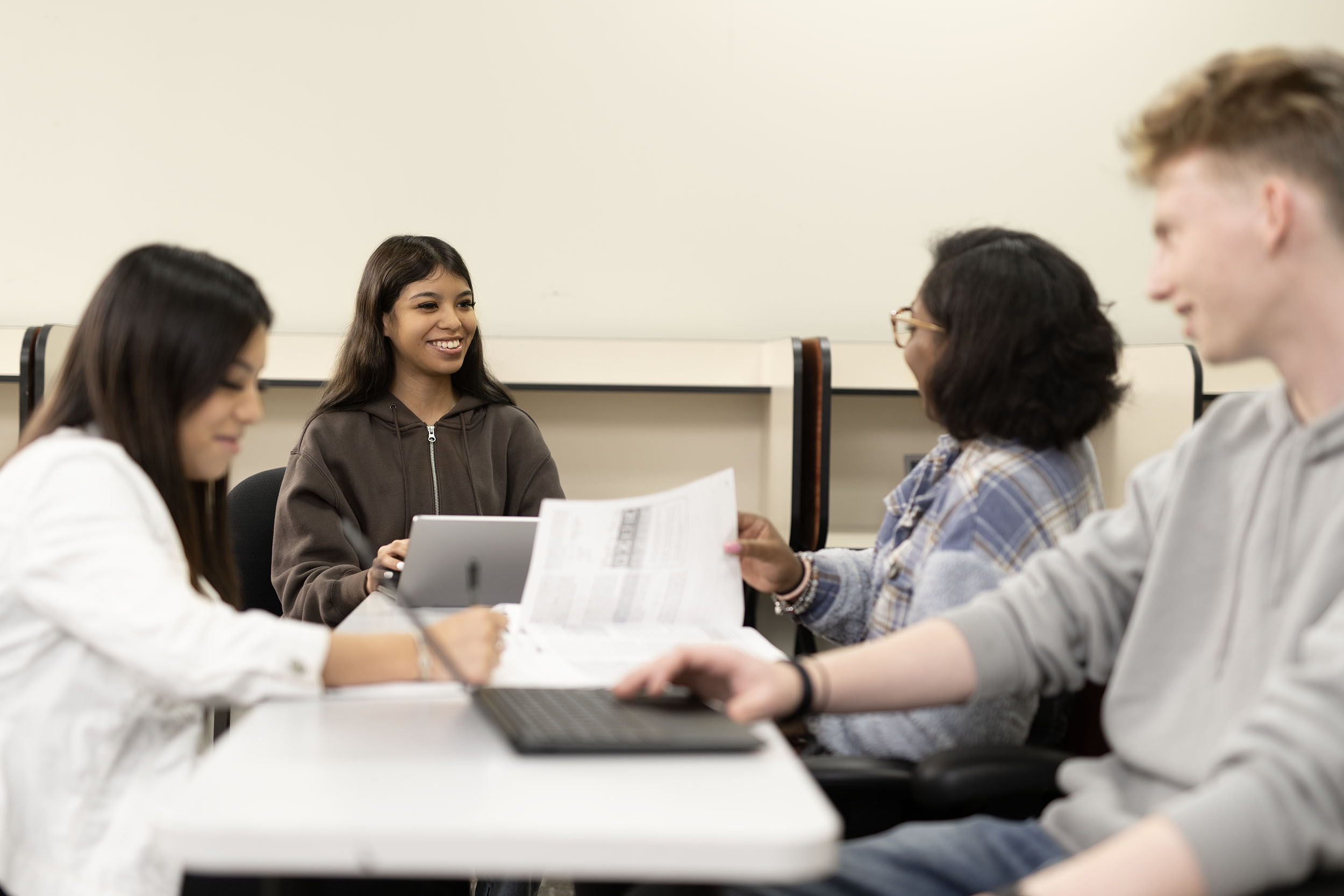 Students collaborating on project in classroom setting.