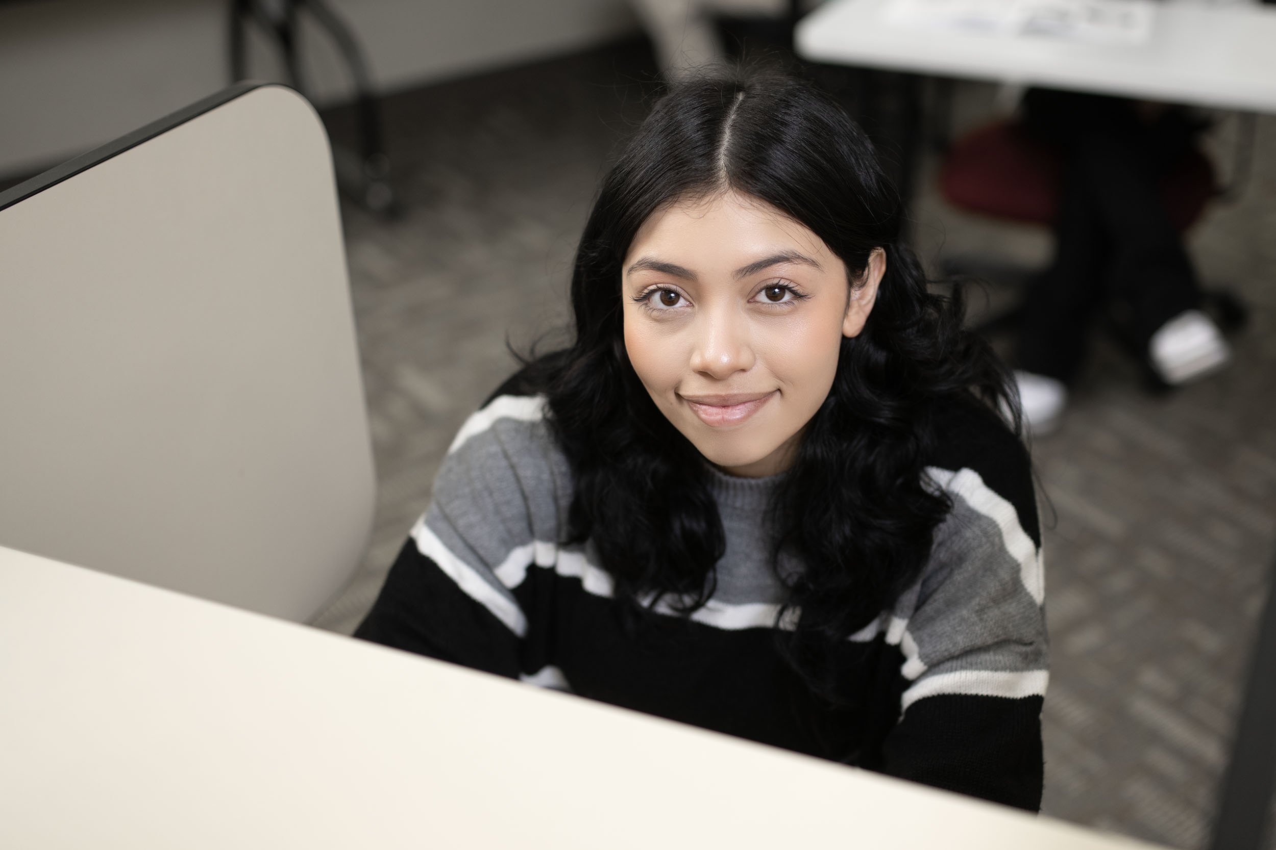 Young woman smiling sitting in office environment