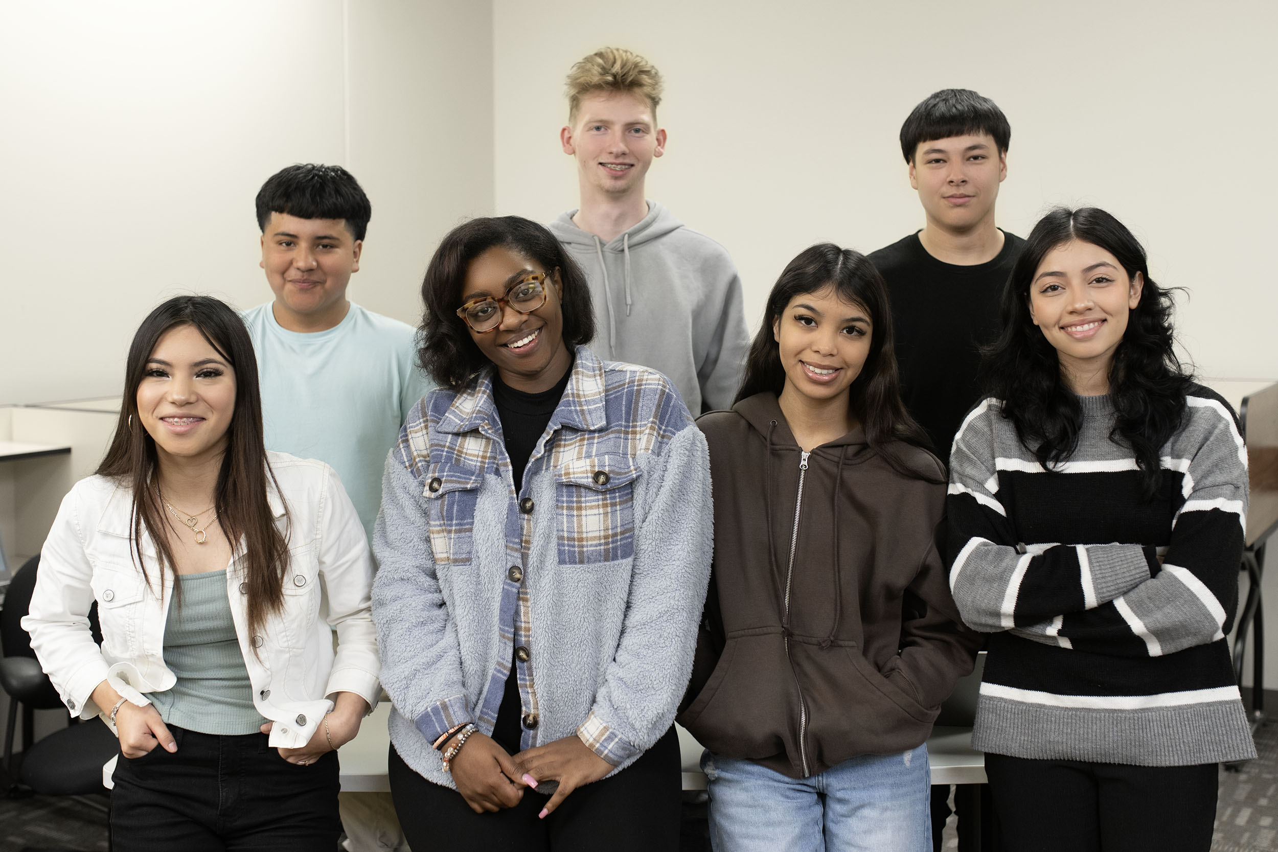 Diverse group of students smiling together in classroom