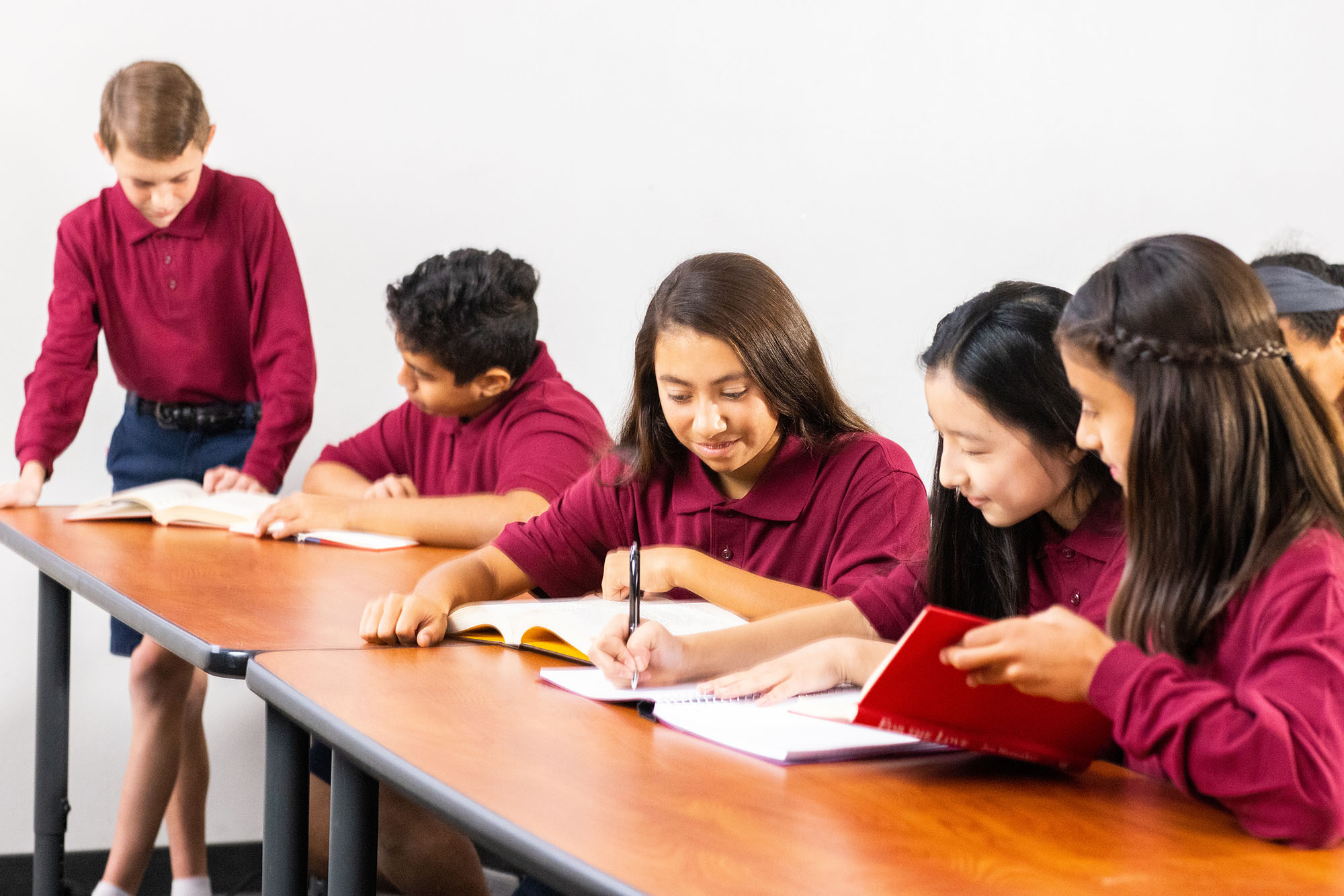 Students in uniform studying together in classroom