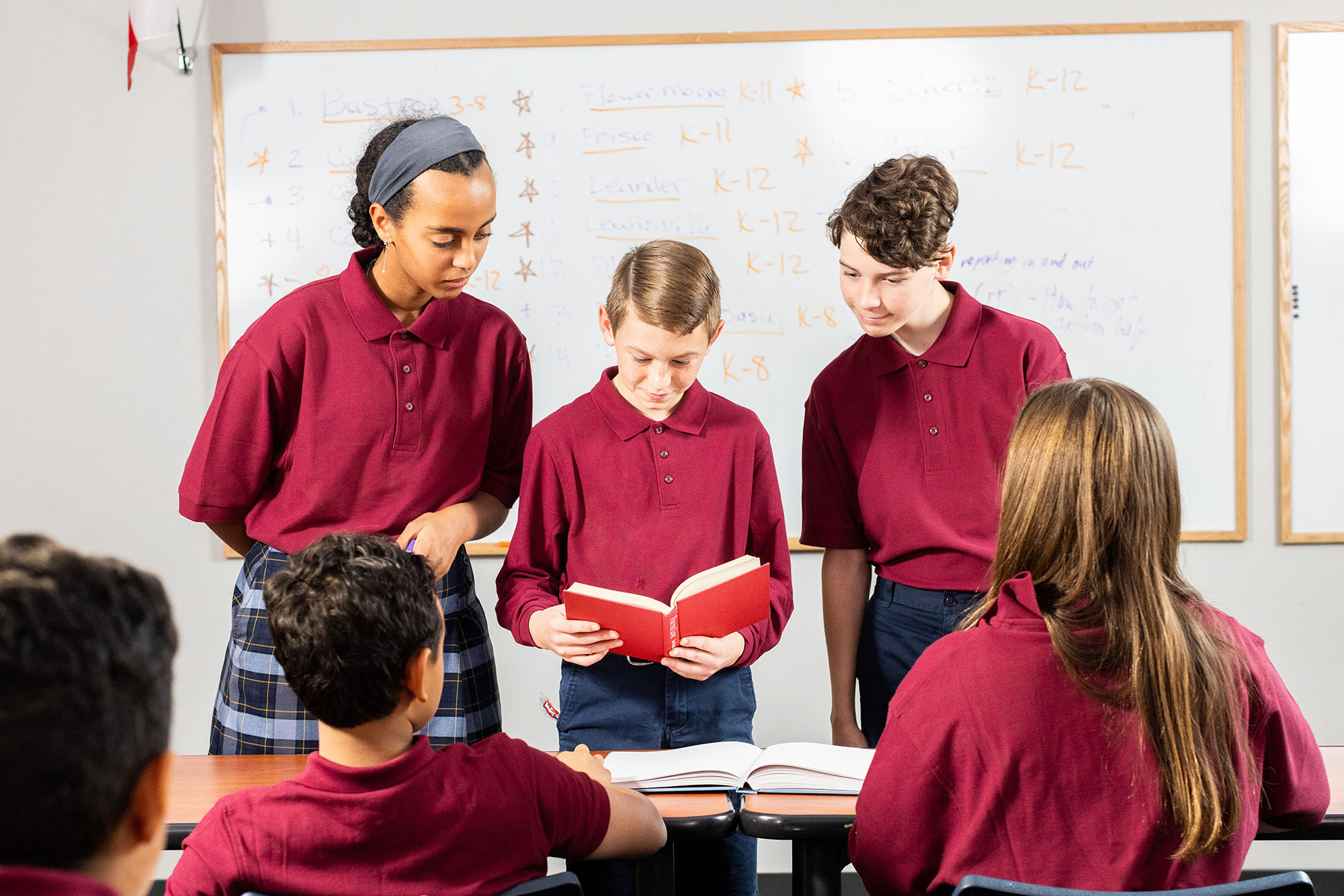 Students in uniforms engaged in group study session