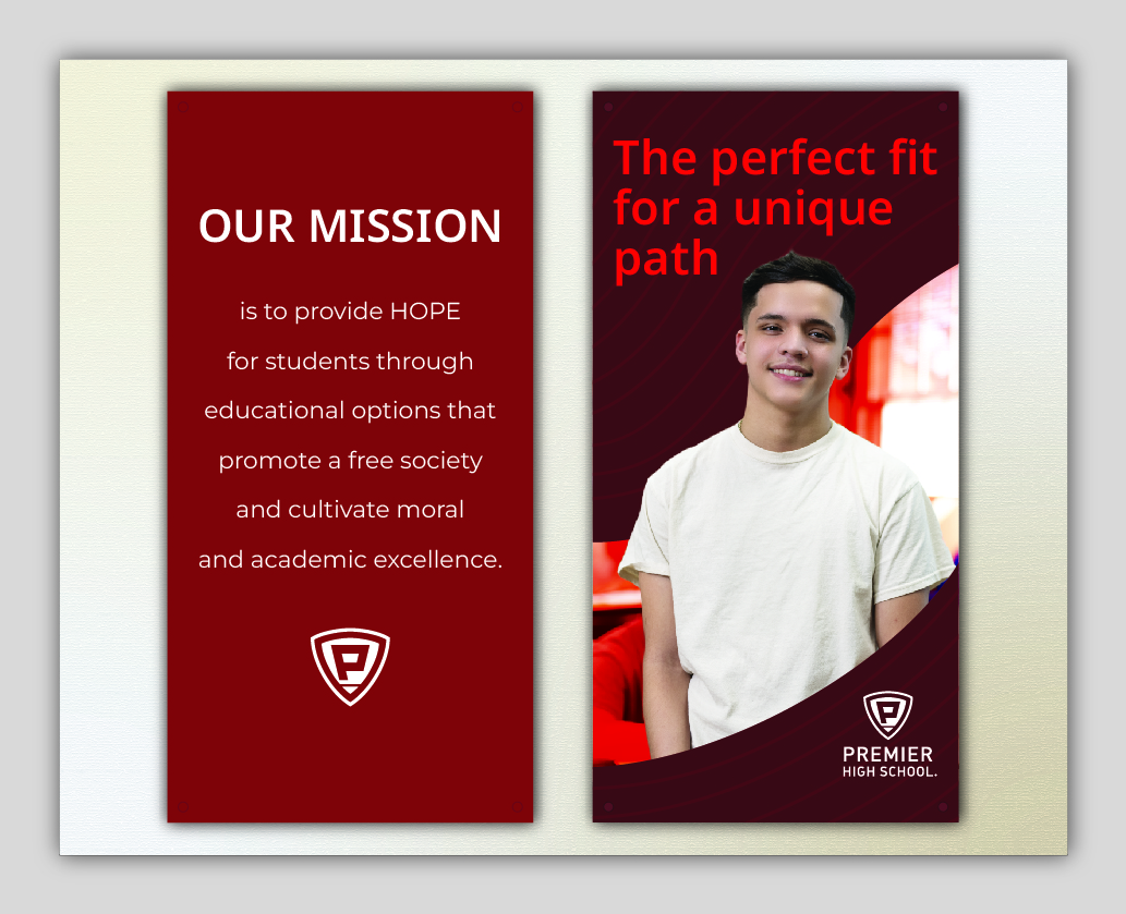 Young student smiling beside school mission statement poster