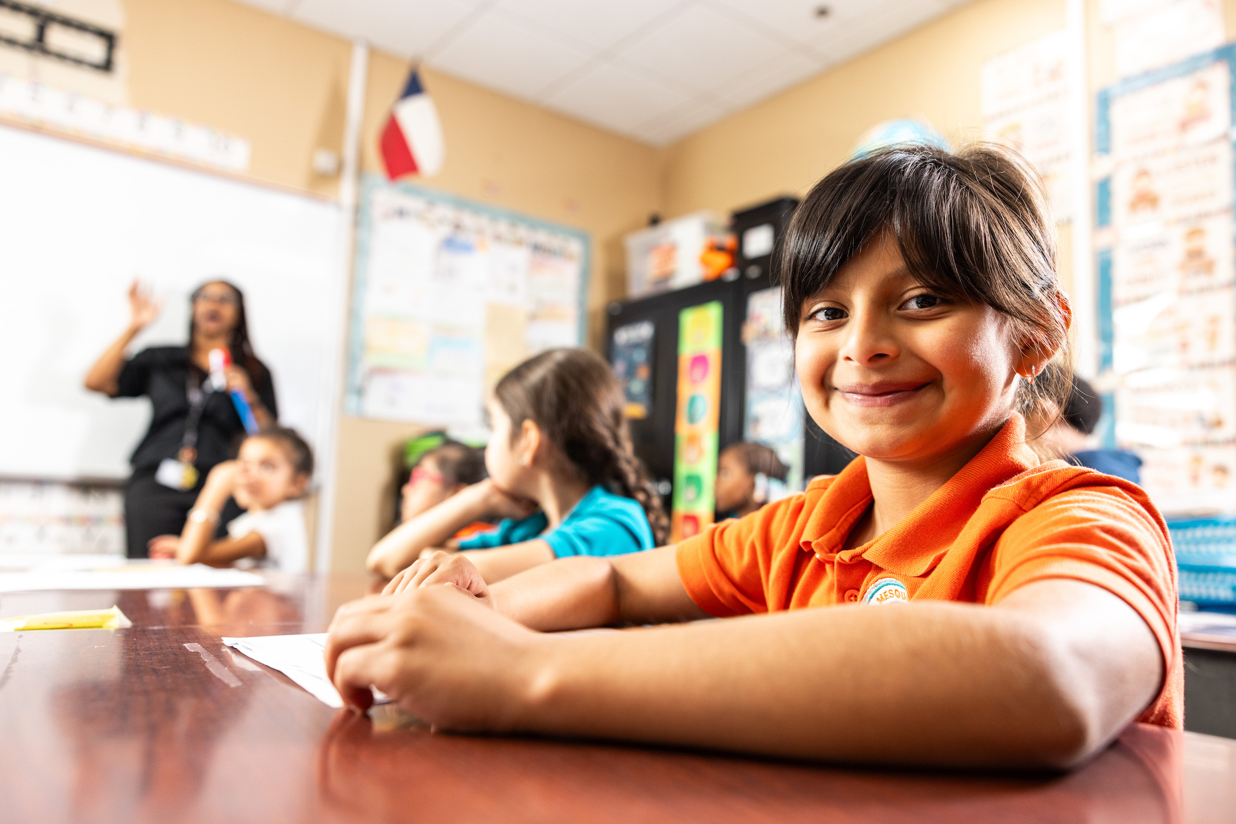 Smiling student sitting in a classroom setting
